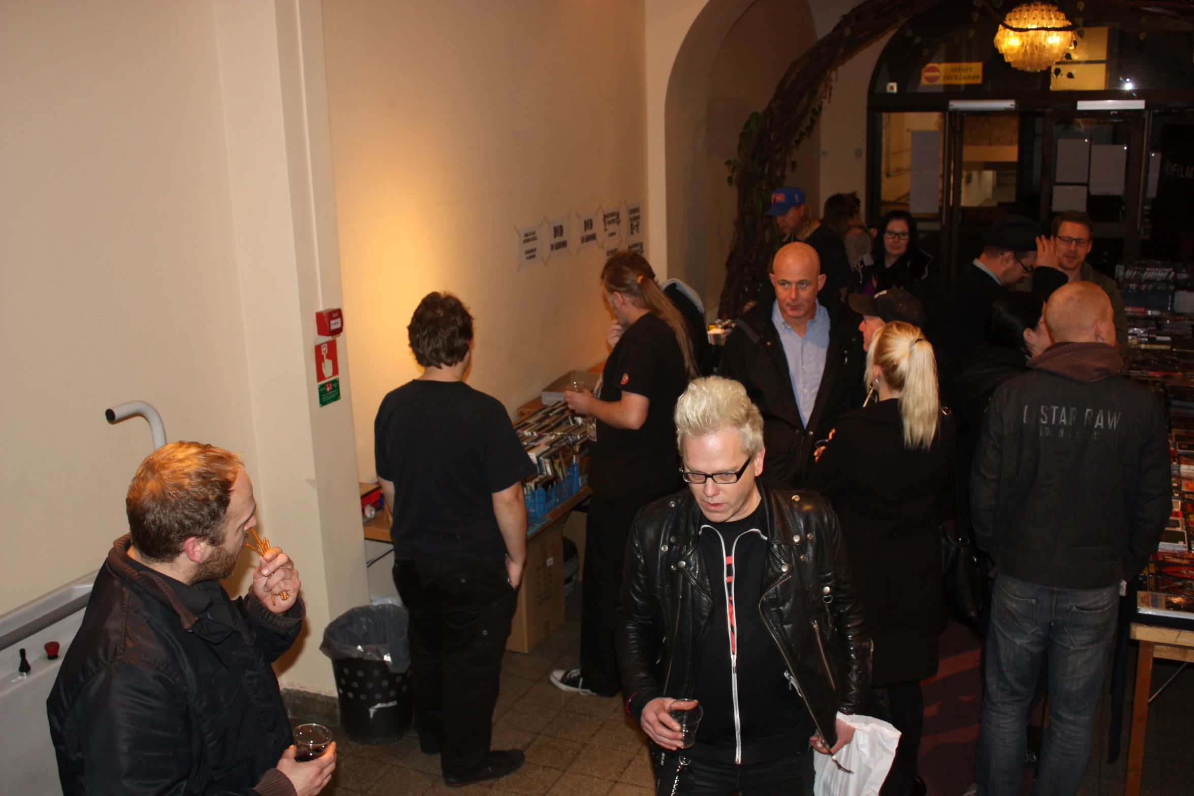 a crowd of people standing in line at a social gathering