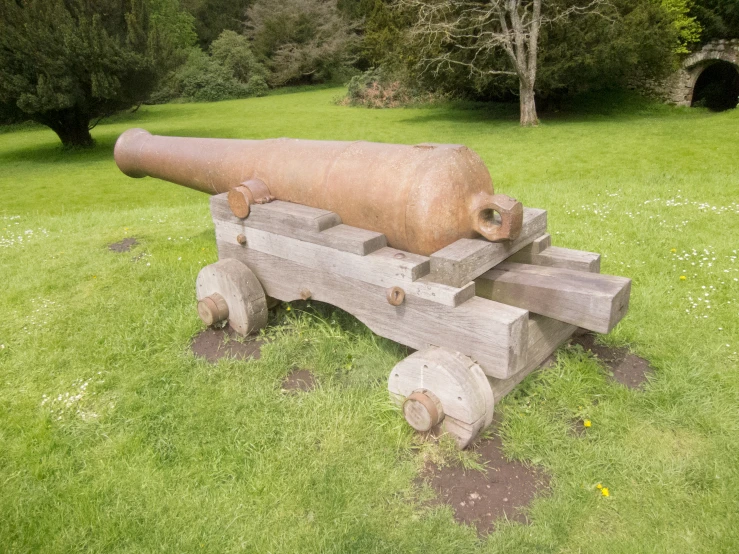 a brown cannon sitting on top of a wooden bench