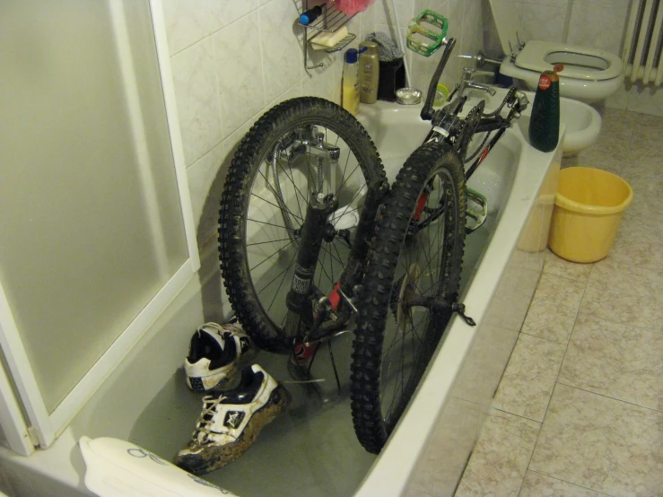 a bicycle is in a tub with a shower curtain