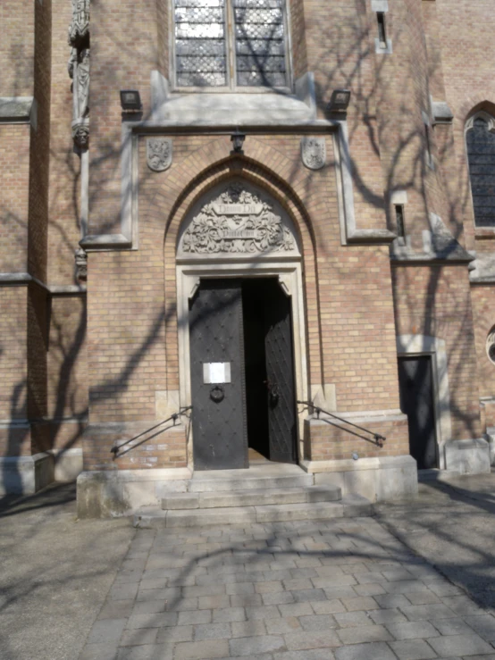 an entry to a brick building with a clock on it