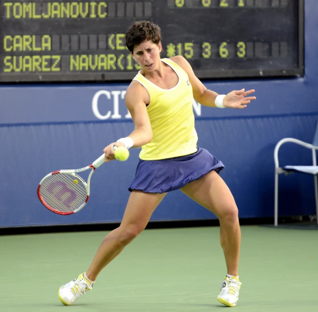 a female tennis player is trying to hit the ball