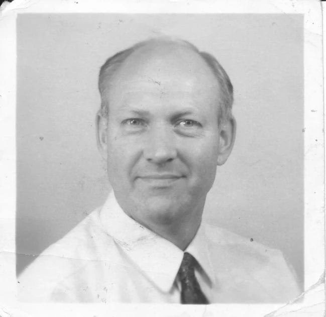 a man in a white shirt and tie with a black and white background
