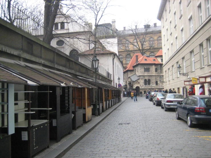 a city street with several stores line the street