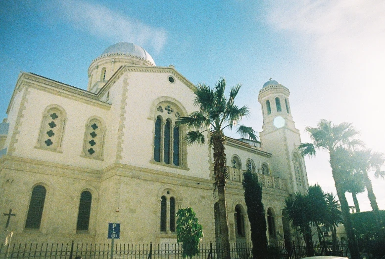 a view of a building with palm trees around it