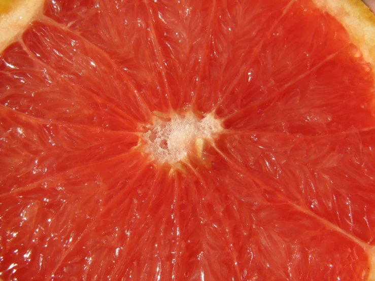 a red gfruit sliced in half sitting on a table