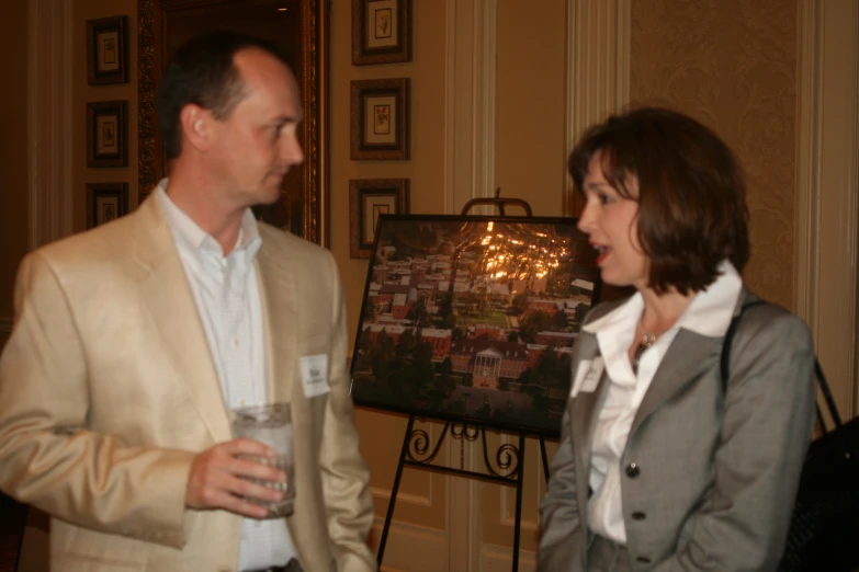 man and woman smiling at each other with drinks