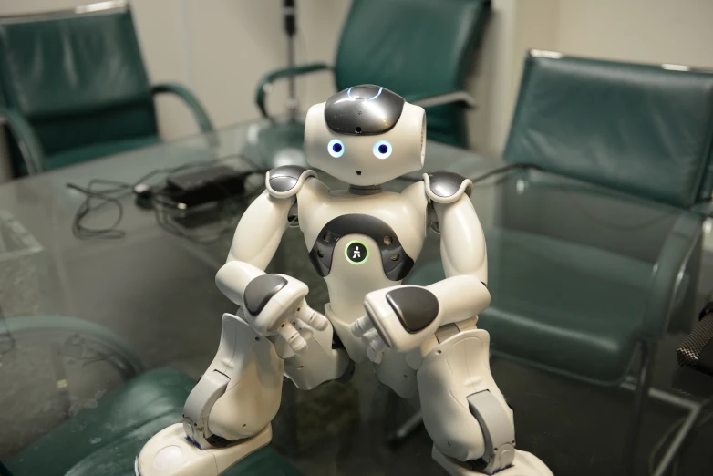 a robot sitting at a conference table