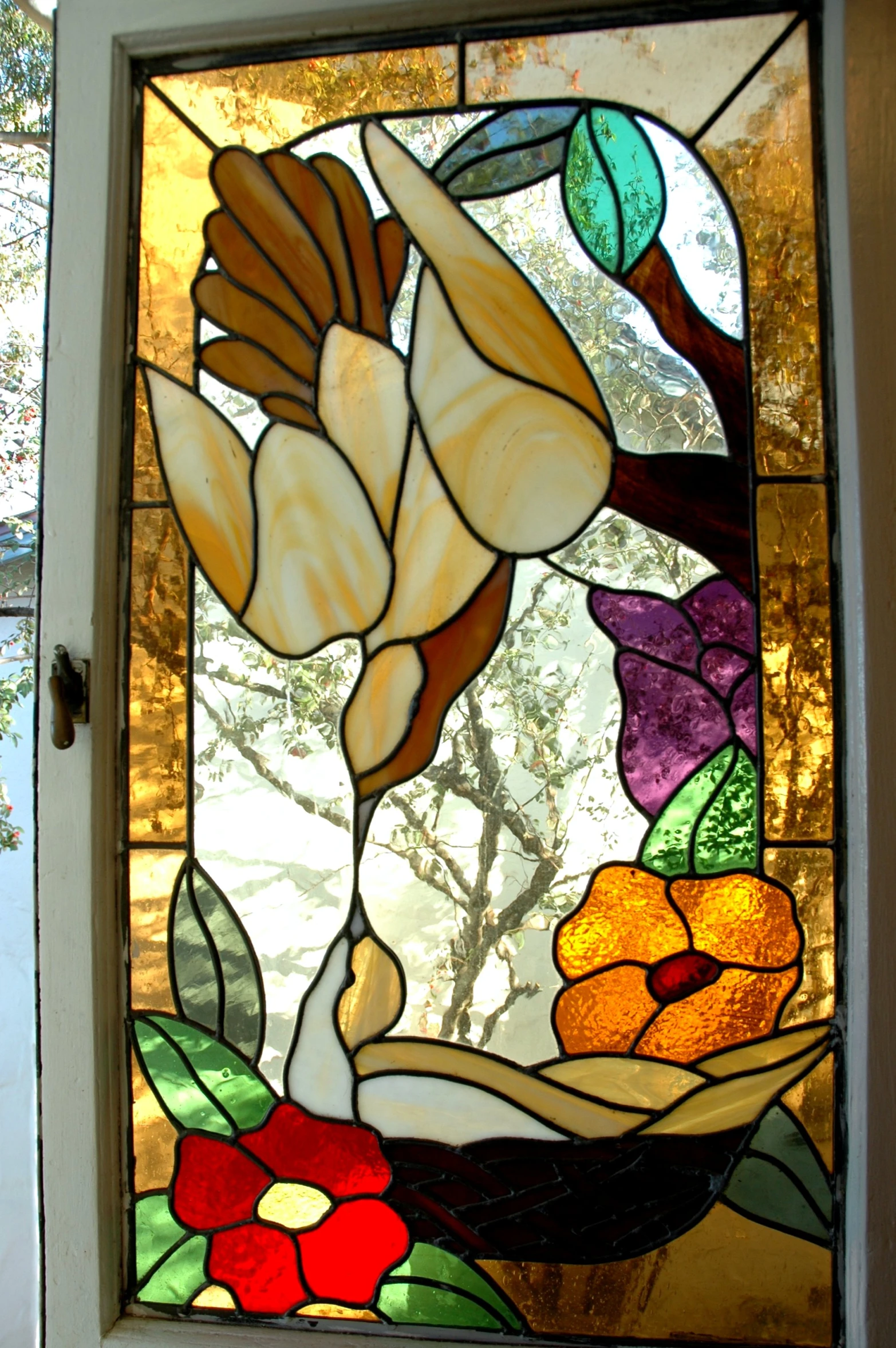 a colorful flower is painted on a glass window