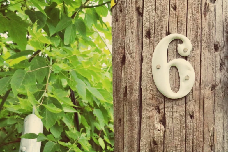 a number is on a wood post next to another number