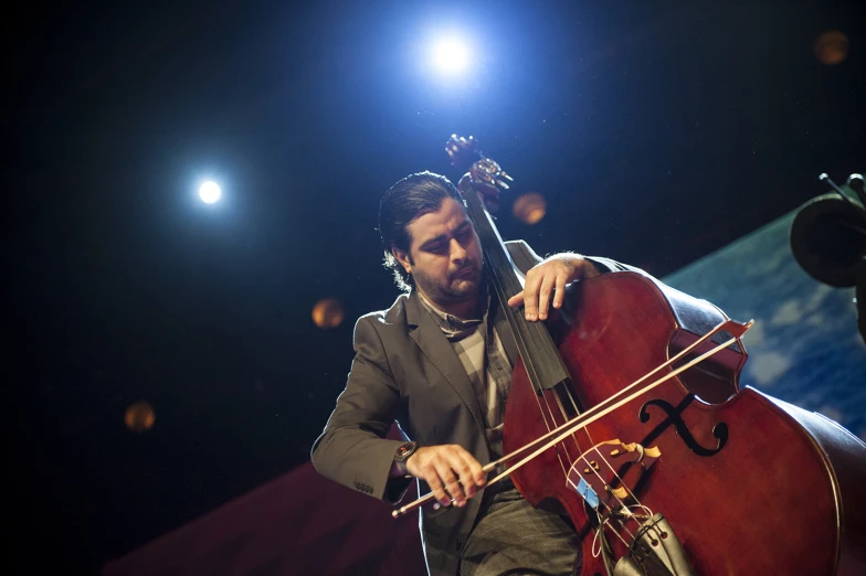 a man playing the contrabas with his hands in it