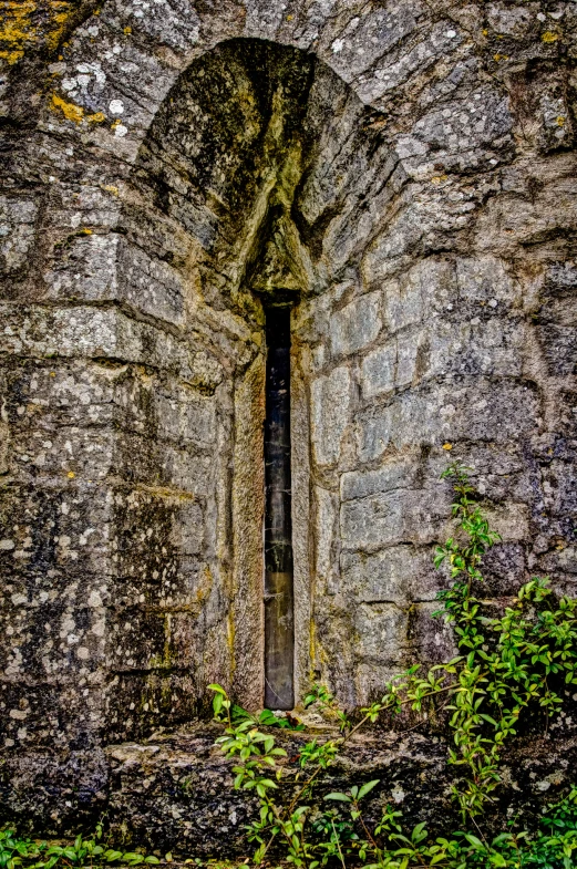 an ancient doorway between two large brick walls