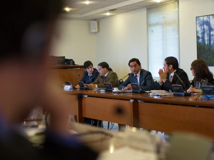 several people at a large table and one is sitting