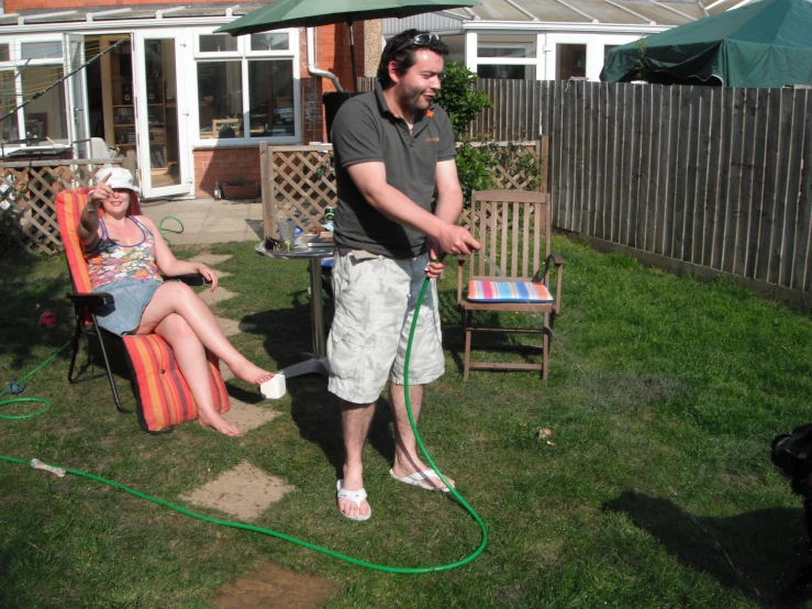 two people sitting on lawn chairs playing with a frisbee