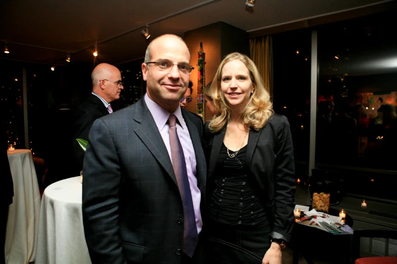 a man and woman standing in front of a dining room table