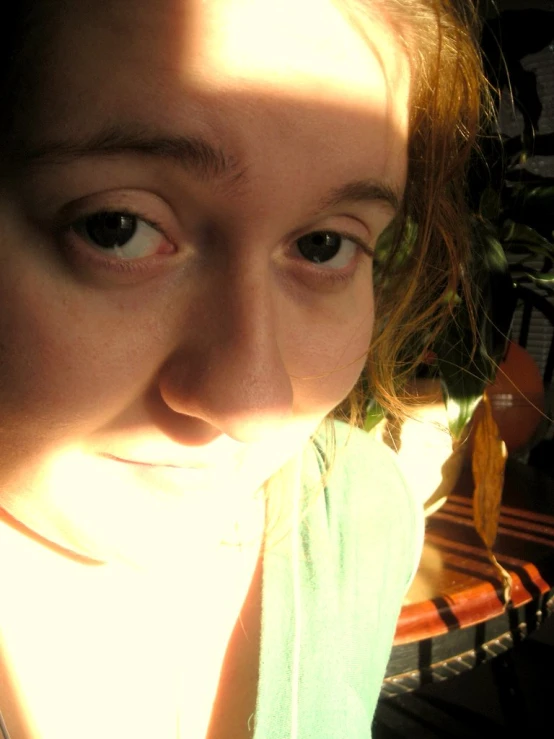 a woman standing on a wooden bench in the sunlight