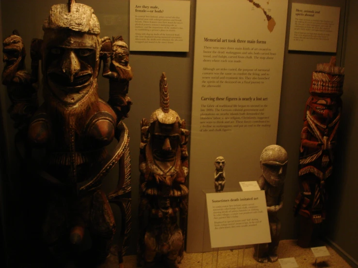 a display with carved figures and signs in it