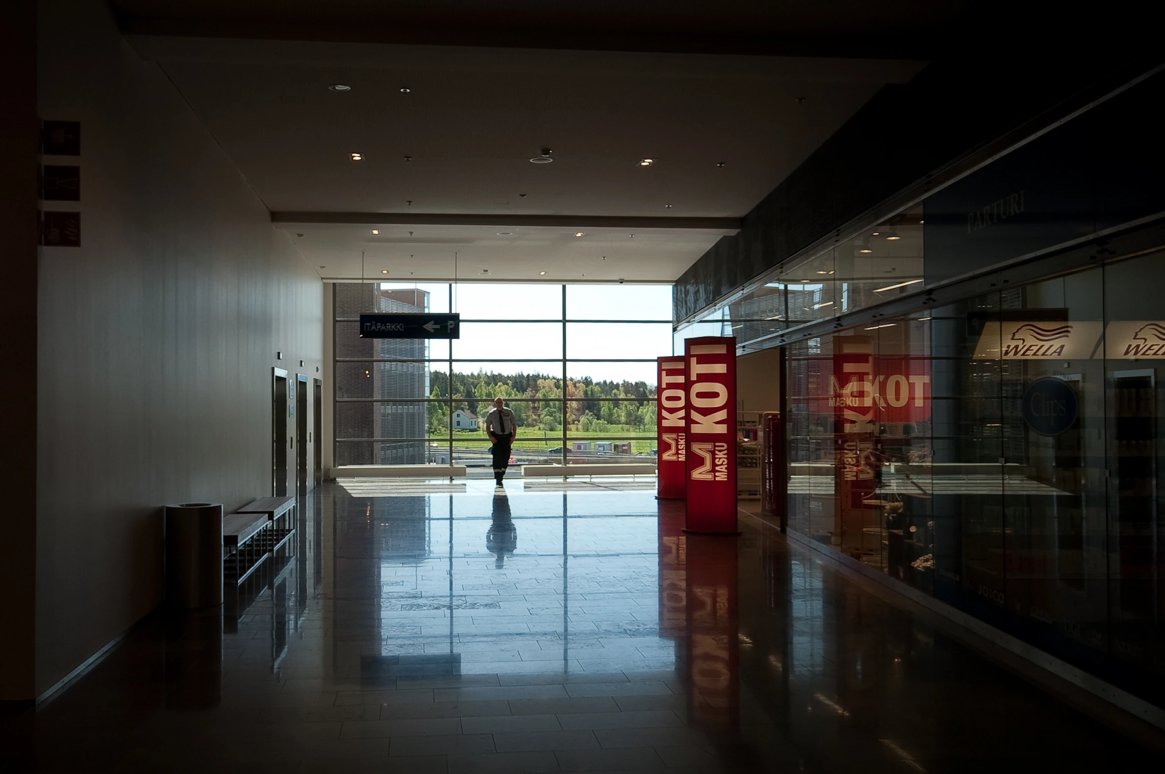 the hallway inside a building is empty, with signs saying you can't buy