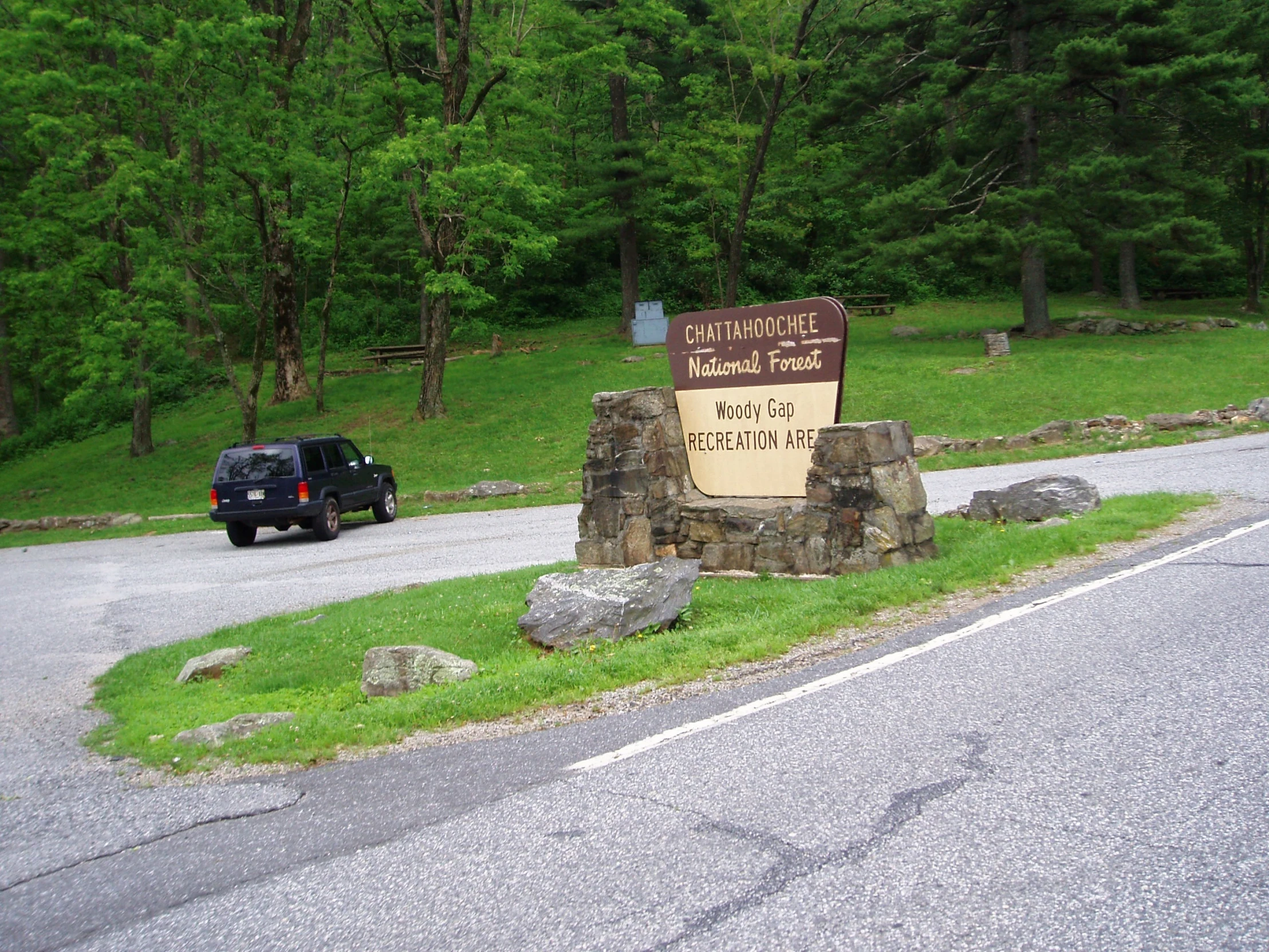 there is a sign on the side of the road by the road