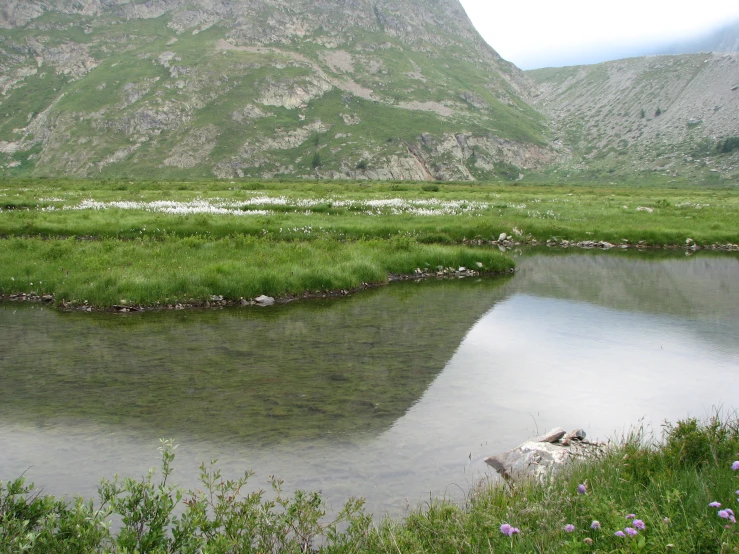 the large mountain range is behind a body of water