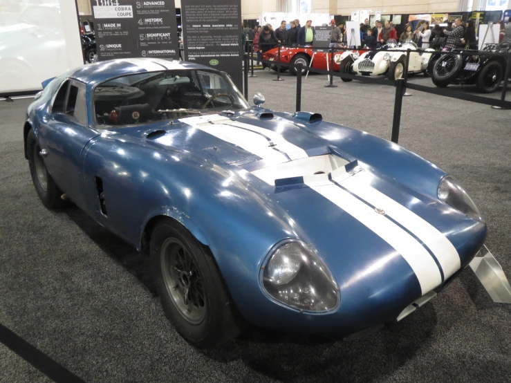 an old vintage race car is on display at a show