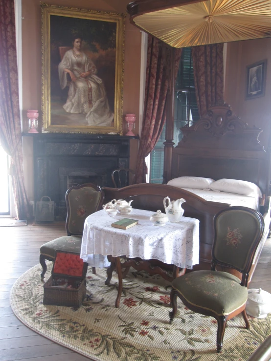 a table with two chairs is shown in a bedroom