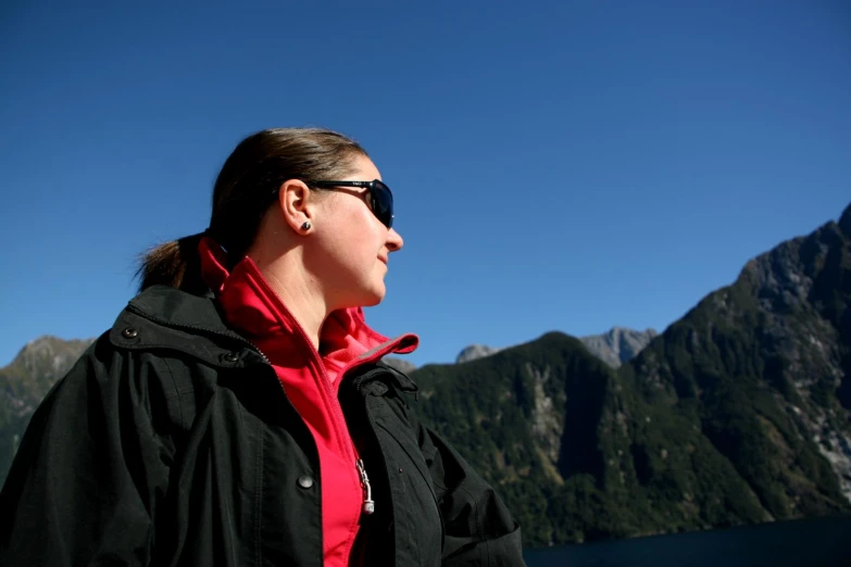 a woman in red looking at some mountains