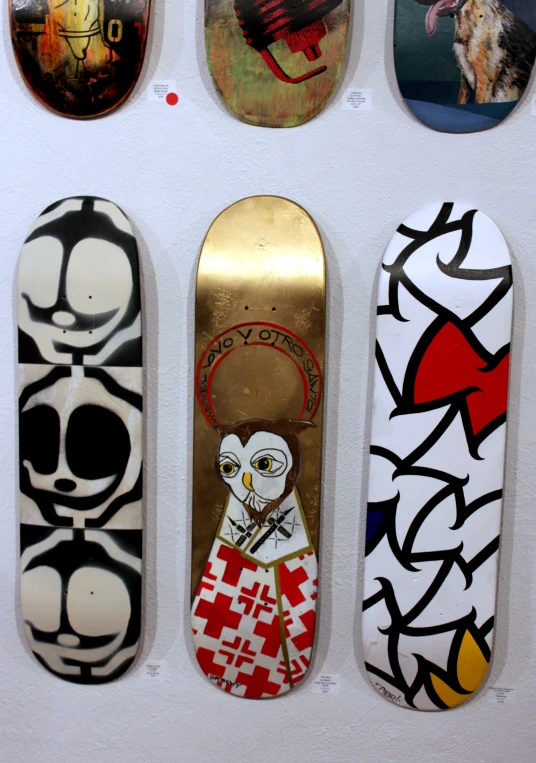 several skate boards are arranged on a wall