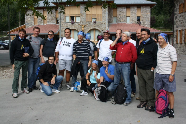 many people are posing for the camera near the building