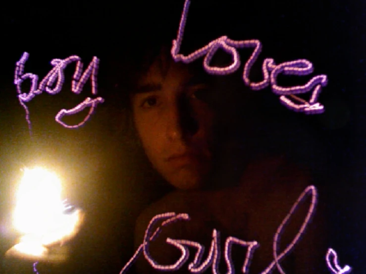 someone holding a lit candle in their hand that reads baby loss girl