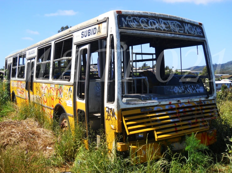 an abandoned bus is shown near the brush