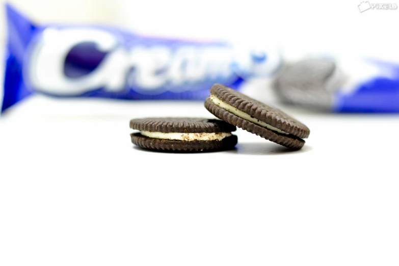 two oreos next to a chocolate cookie