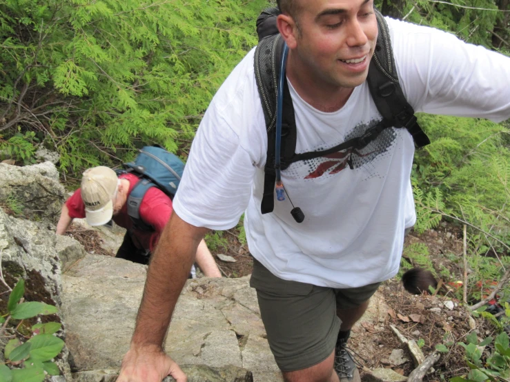 two people hike down rocks near each other