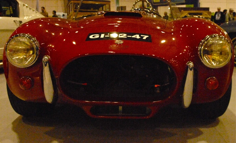 an old fashioned car that is on display