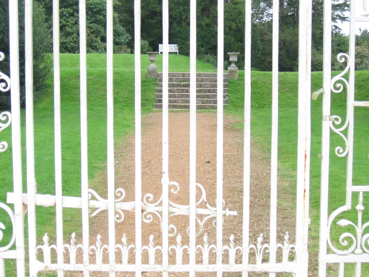 an old cemetery behind iron gates, in a park