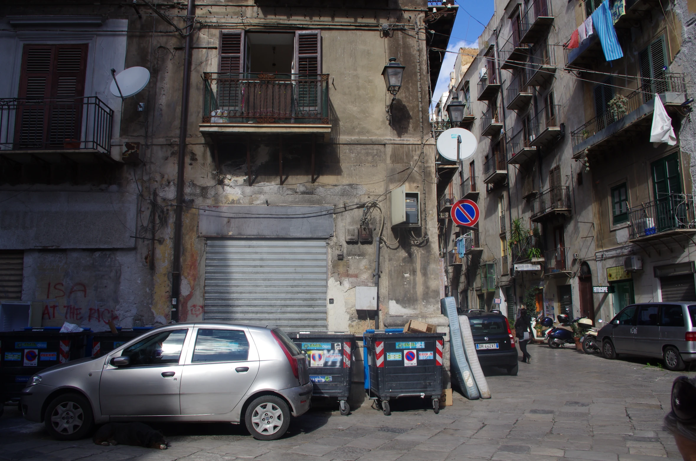 a car parked in front of a dilapidated building