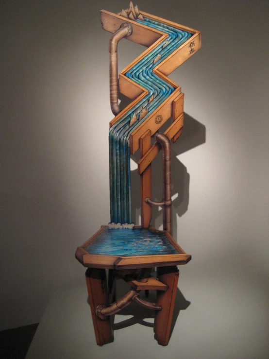 an artistic chair with a back rest filled with blue pipes