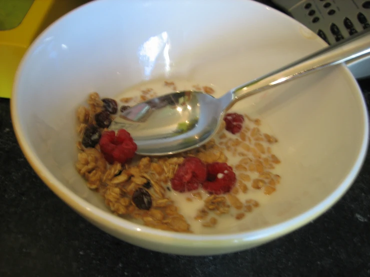 a bowl with a spoon in it on top of some rice