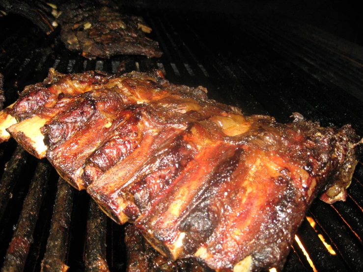 a bbq steak is being cooked on a grill