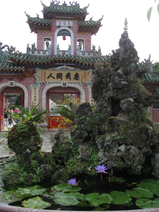 a water garden with a statue on top of it