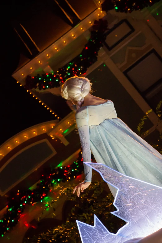 the woman in white dress is dressed as a fairy with a star