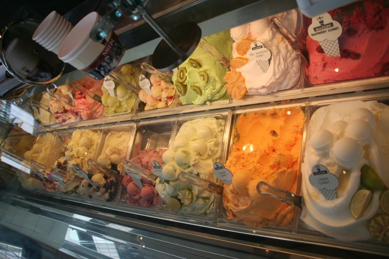a selection of gelato flavors on display in a shop
