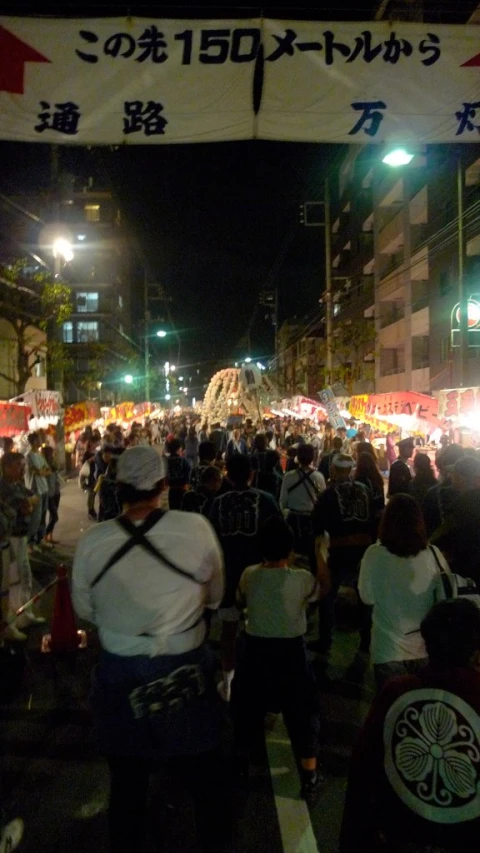 a crowd of people are gathered on the street at night