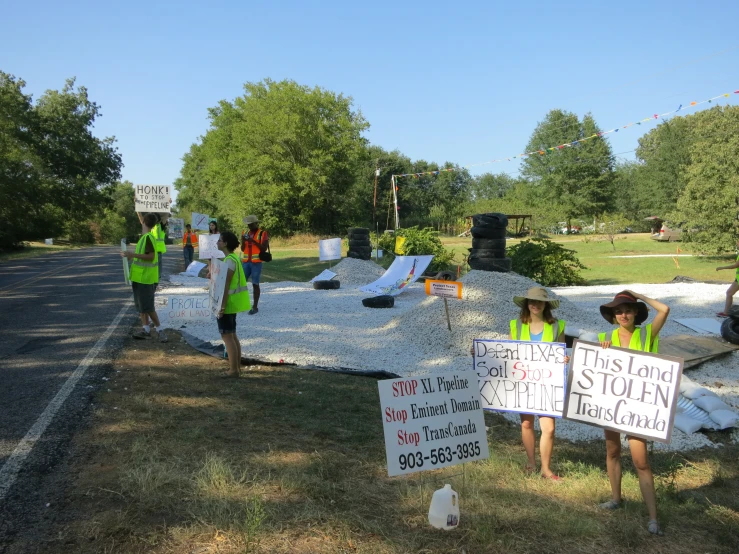 people are protesting outside during a protest in front of an outdoor concert