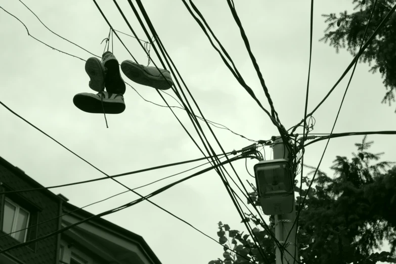 a view up at a telephone pole with many electric wires