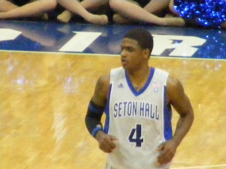 a young man holding a basketball during a game