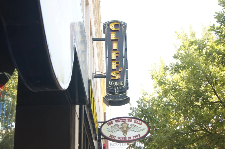 a sign for a restaurant hanging from a building