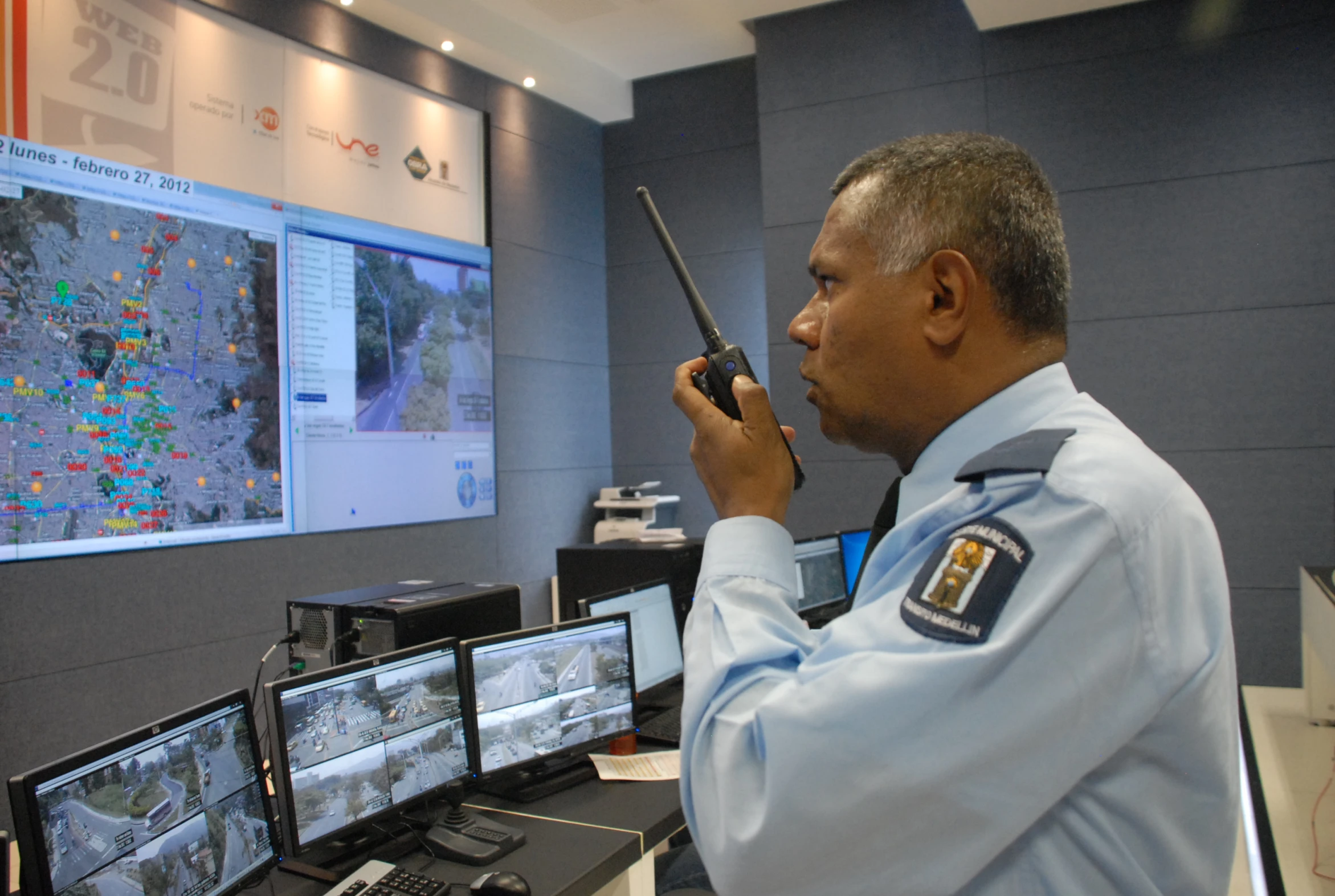 the officer in the blue uniform is using a cell phone