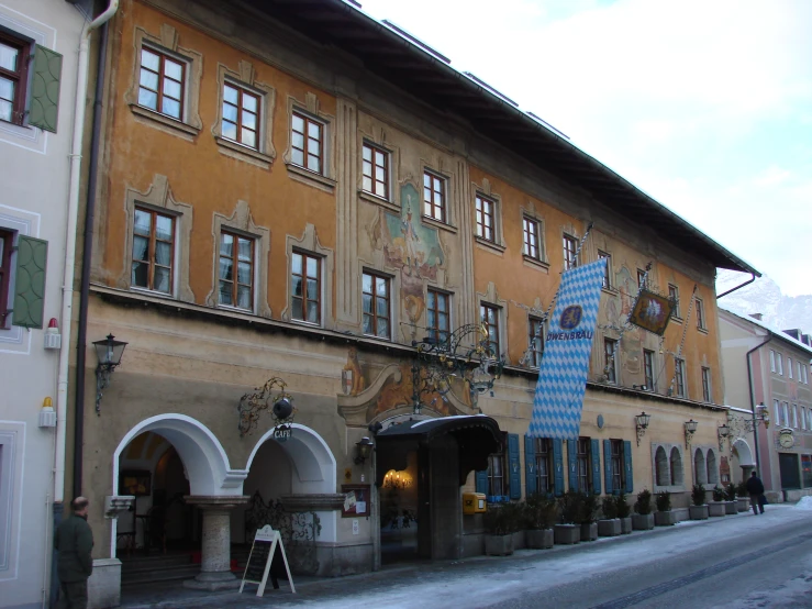 a person is sitting outside of a large building