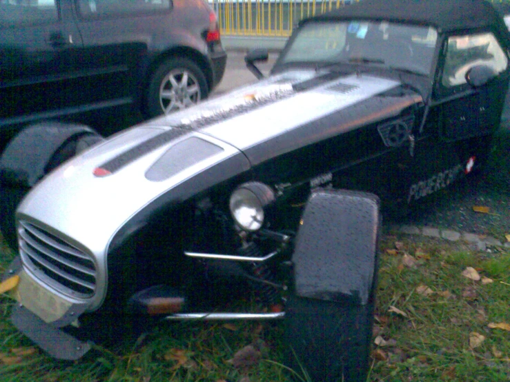 an old race car on display in a parking lot