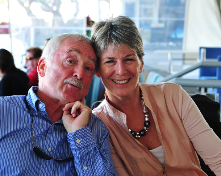 an older couple is having fun at a restaurant